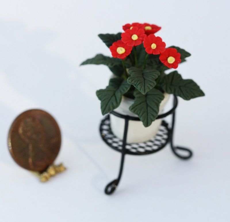 Pot of Red Daisies in a Black Wire Plant Stand