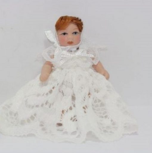 Red Haired Baby Doll in a White Lace Dress