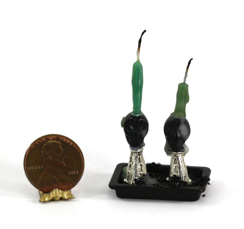 Pair of Black Skull Candle Holders with Green Candles on a Tray