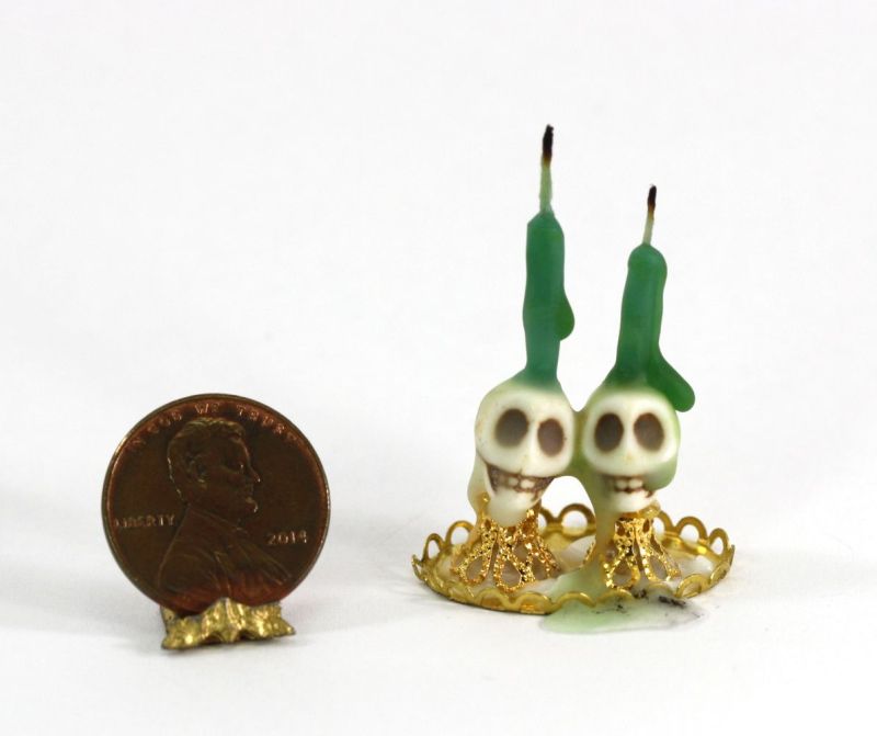 Set of Skull Candle Holders with Green Candles on a Gold Tray
