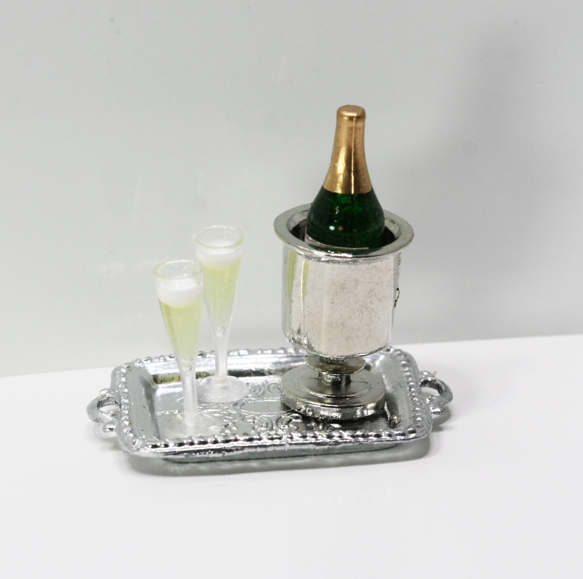 Bottle of Champagne in Holder with 2 Filled Glasses on A Silver Tray